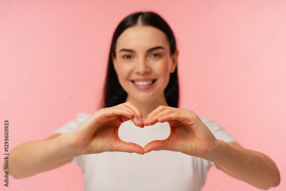 Bright and cheerful individual expressing love and positivity through a heart gesture with hands. The soft pastel background enhances the warm and loving feeling conveyed by the composition. Bright and cheerful individual expressing love and positivity through a heart gesture with hands. The soft pastel background enhances the warm and loving feeling conveyed by the composition.