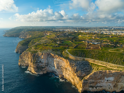 Drone view of green hills, countryside, cliifs. Mediterranean sea, blue sky. Malta island