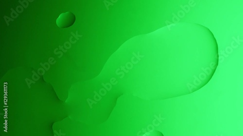 a large drop flows and connects with another on a green gradient background