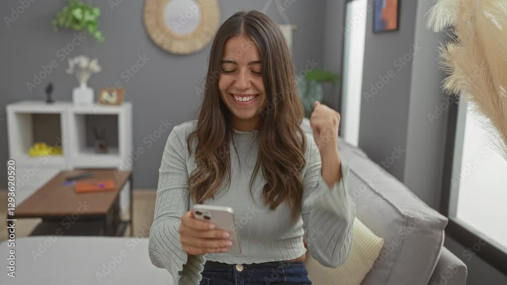Woman smiling while using smartphone in cozy living room setting, showcasing happiness and connection with modern technology, sitting comfortably on a couch. Woman smiling while using smartphone in cozy living room setting, showcasing happiness and connection with modern technology, sitting comfortably on a couch.