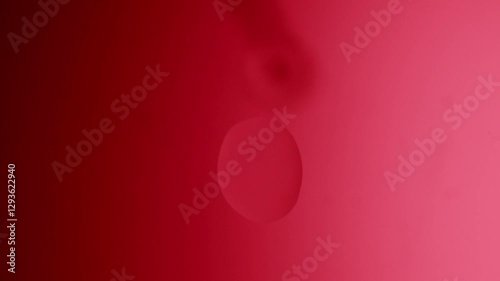 drops drip from above and scatter across a red gradient background