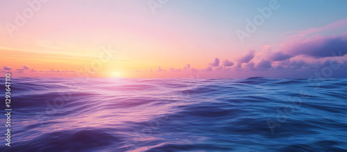 Vivid colors of dawn with the sunrise above the ocean The horizon features a sky with clouds and waves A natural background showcasing a gradient of blue and pink Copy space No people present Sunli