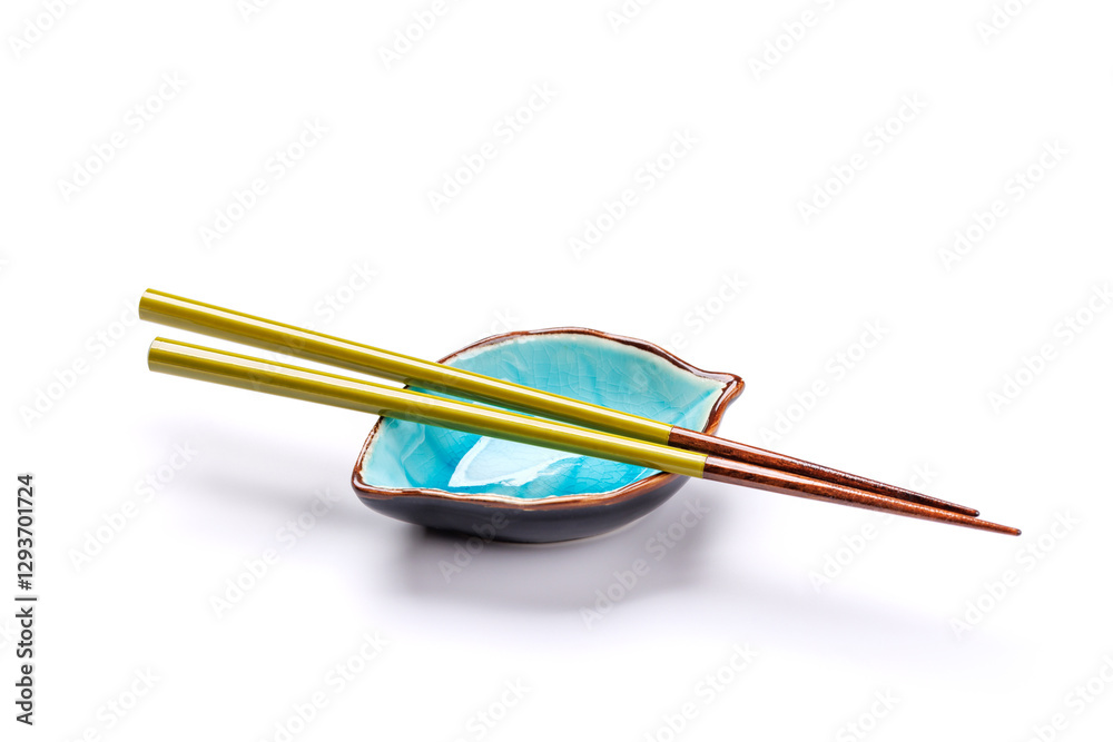 A sushi chopsticks and a small bowls, elegantly arranged on a clean white background A sushi chopsticks and a small bowls, elegantly arranged on a clean white background