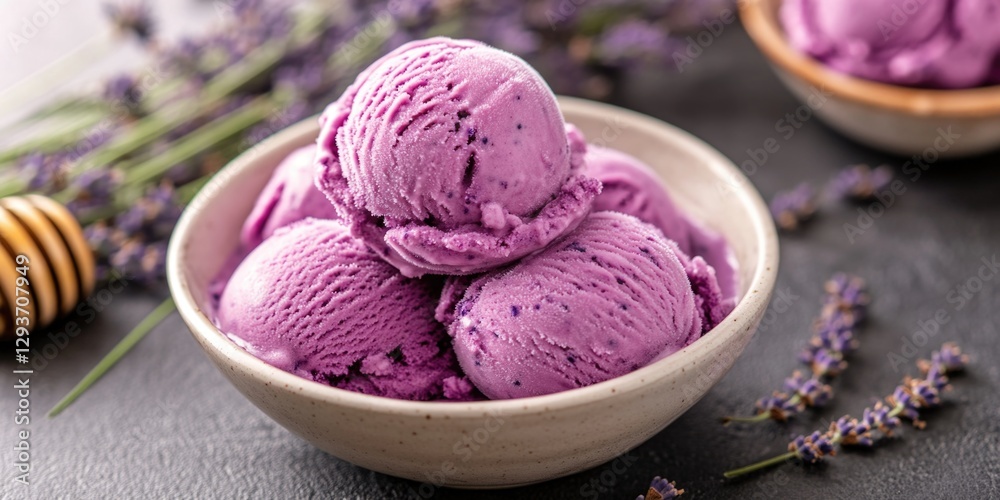 A bowl of purple ice cream sits next to a container of honey, ready for a sweet treat A bowl of purple ice cream sits next to a container of honey, ready for a sweet treat