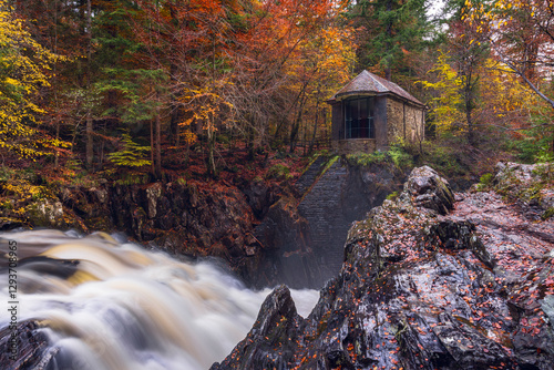 Ossian’s Hall at The Hermitage, Dunkeld, overlooking the rushing Black Linn Falls on the River Braan, surrounded by vibrant autumn woodland in scenic Perthshire, Scotland. photo