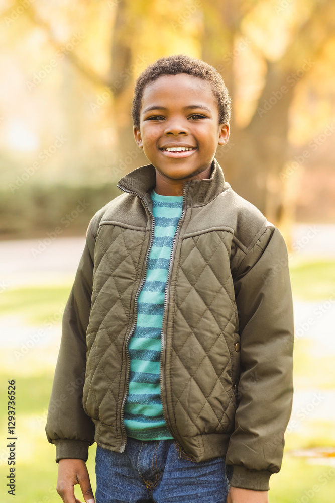 Smiling boy in autumn jacket enjoying sunny day in park Smiling boy in autumn jacket enjoying sunny day in park