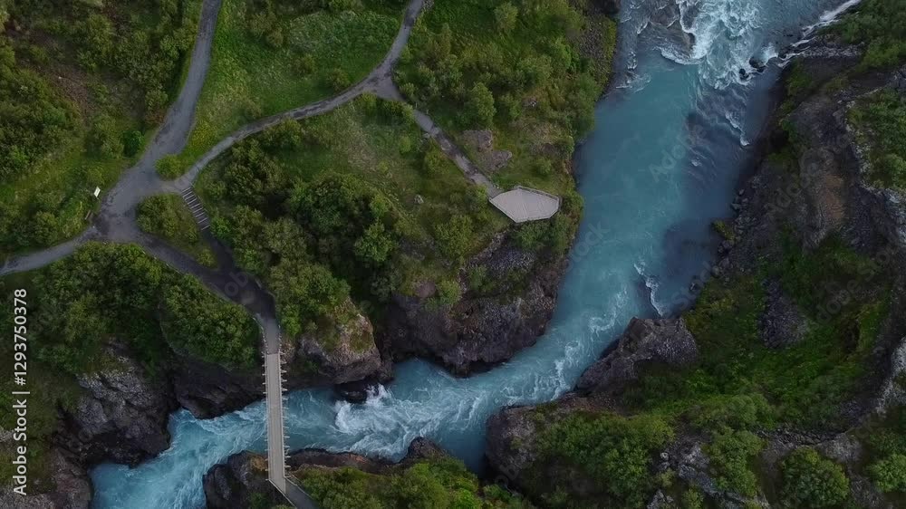 Aerial drone shot of the trails and view points surrounding the Hvitá glacier river. Close up on the fast flowing stream and powerful currents of the clear blue water