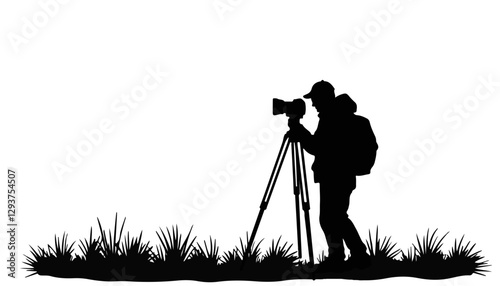 Silhouette photographer taking pictures against a grassy background