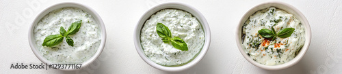 Set of delicious tzatziki sauces in bowls, isolated on a white background