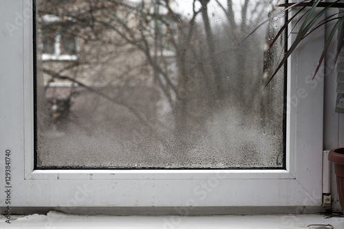 plastic window is fogged up. drops of water gathered on the glass