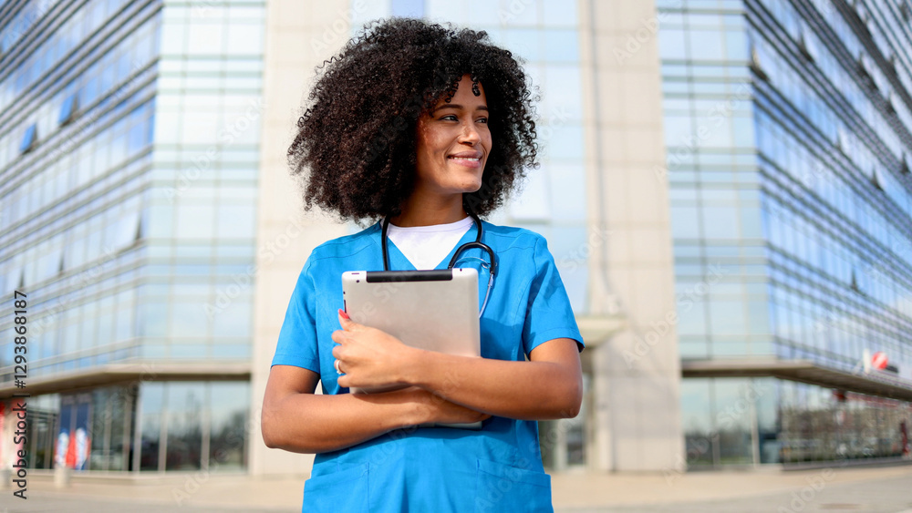 Portrait of a beautiful, young African American nurse standing in front of the medical clinic Portrait of a beautiful, young African American nurse standing in front of the medical clinic