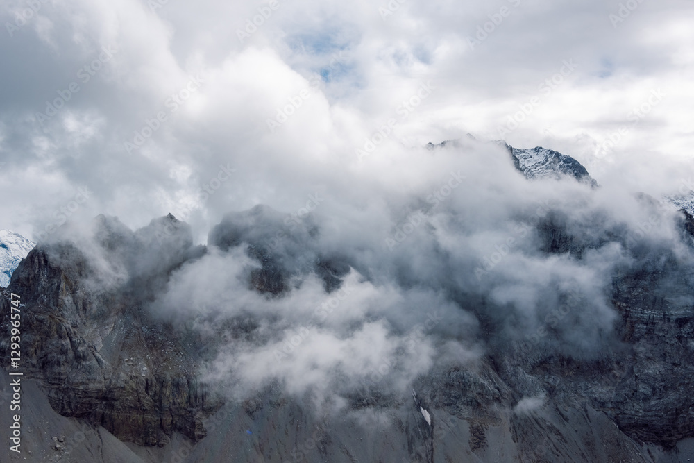 Fototapeta premium A rocky peak shrouded in clouds.