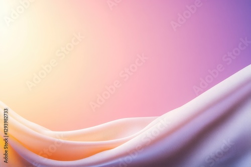 Soft fabric drapes gracefully, reflecting warm hues of orange an