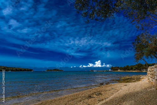 Fototapeta Naklejka Na Ścianę i Meble -  Wild beaches without people, a moment before the storm and storm on the Adriatic Sea, around Rovinj, Istrian heavy sky with clouds, rough waves, wild nature
