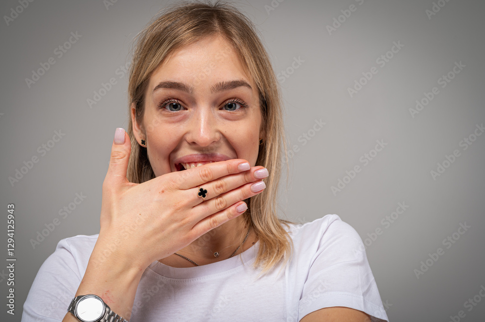 Happy, emotional young girl with blond hair smiling and leaning on wooden chair on neutral background. Cheerful woman in casual white t-shirt, confidence, joy, positivity, space for inscription Happy, emotional young girl with blond hair smiling and leaning on wooden chair on neutral background. Cheerful woman in casual white t-shirt, confidence, joy, positivity, space for inscription