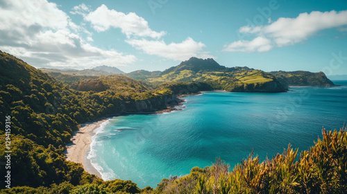 Lush green island surrounded by crystal clear waters and rugged coastline under a bright blue sky