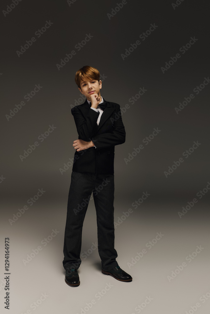 Elegant preteen boy showcasing sophisticated fashion in a stylish studio Elegant preteen boy showcasing sophisticated fashion in a stylish studio