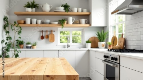 wooden kitchen table in bright modern kitchen with white cabinets, open wooden shelves, green plants, cooking utensils, and window view, concept of home interior, real estate, kitchen design