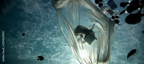 Underwater plastics drift in ocean currents illuminated by sunlight