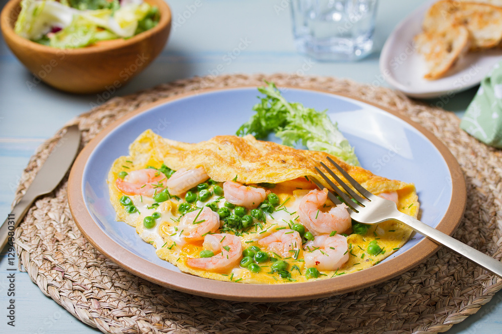 Prawn omelette with green peas on blue plate. Eggs with shrimps Prawn omelette with green peas on blue plate. Eggs with shrimps