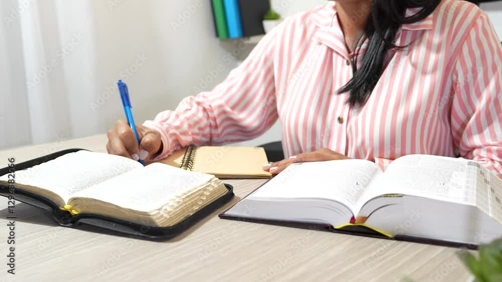 open bible. woman studying the bible and taking notes