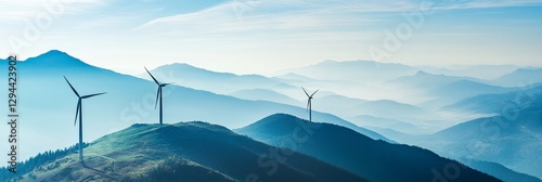 Scenic view of wind turbines on lush green hills with layers of misty mountains in the background under a clear blue sky, symbolizing renewable energy and sustainability.