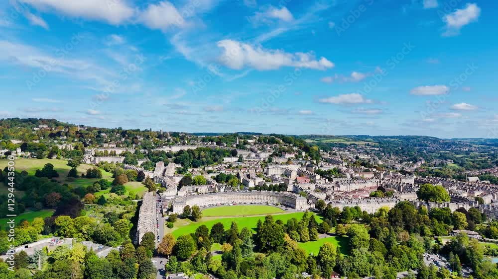 Drone scenic view of The Royal Crescent with buildings and greenery on a sunny day under blue sky Drone scenic view of The Royal Crescent with buildings and greenery on a sunny day under blue sky