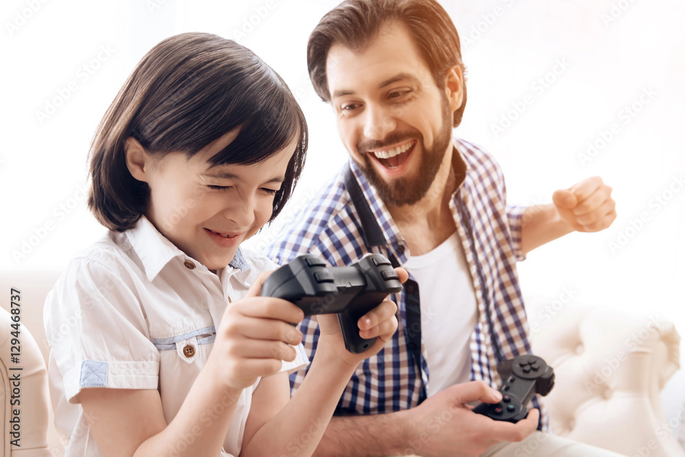 Adult father with joystick rejoice at victory in game with son. Adult father with joystick rejoice at victory in game with son.