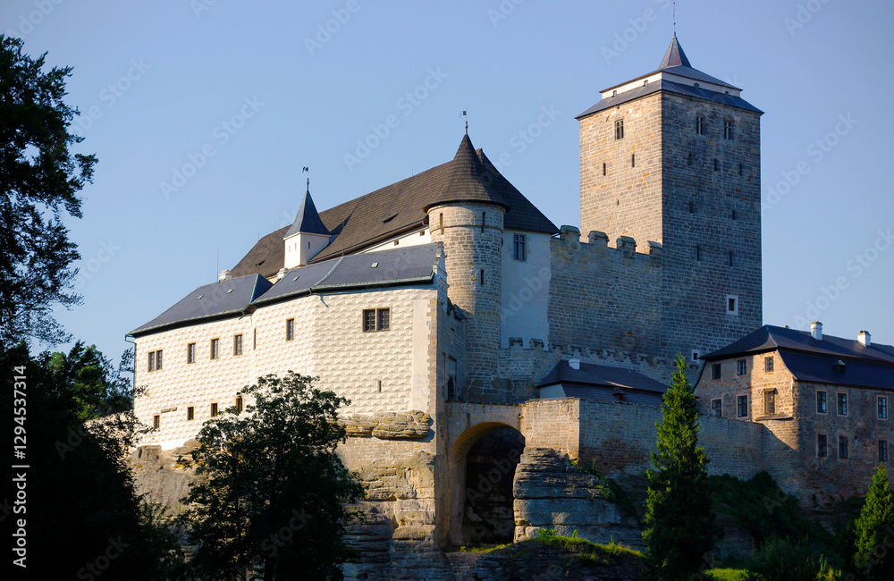 Kost, a Gothic castle lying in the nature region of Bohemian Paradise in the Czech Republic, Europe. A preserved gothic castle with trapezoidal tower in the evening light Kost, a Gothic castle lying in the nature region of Bohemian Paradise in the Czech Republic, Europe. A preserved gothic castle with trapezoidal tower in the evening light