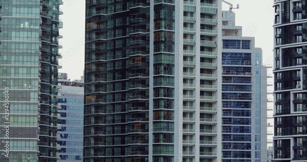Glass skyscrapers in the office center of a modern city. Overview of house facades Glass skyscrapers in the office center of a modern city. Overview of house facades