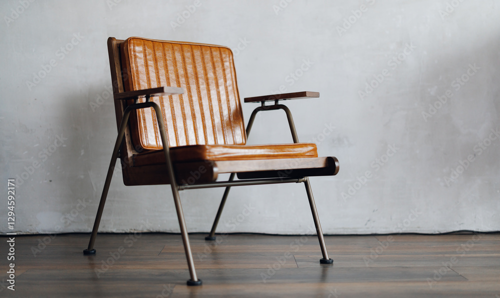 Vintage leather armchair on wooden floor in white concrete room for copy space. Concept of minimalism interior