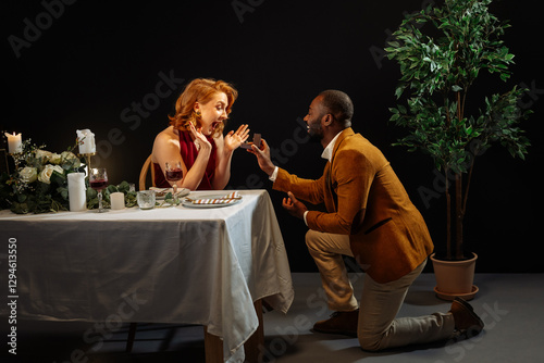 Photography Man proposing to surprised woman during romantic dinner