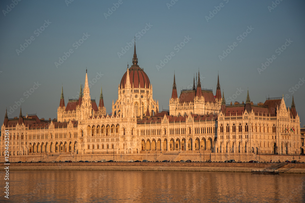 Hungarian Parliament Building reflecting on Danube river at sunset in Budapest Hungarian Parliament Building reflecting on Danube river at sunset in Budapest