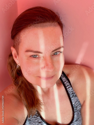 portrait of woman with long hair gathered in a ponytail photo