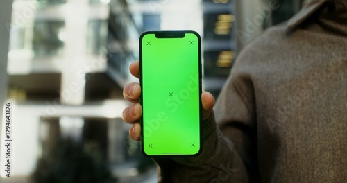 Obraz na plátně Close-up of a mobile phone with a screen forward in the hands of a young man, no face