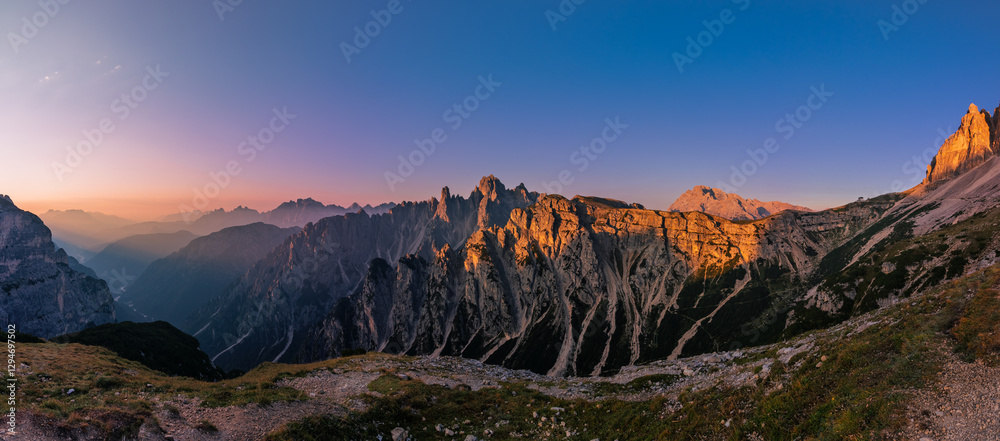 Cadini di Misurina view during sunrise with golden hour warm light panorama