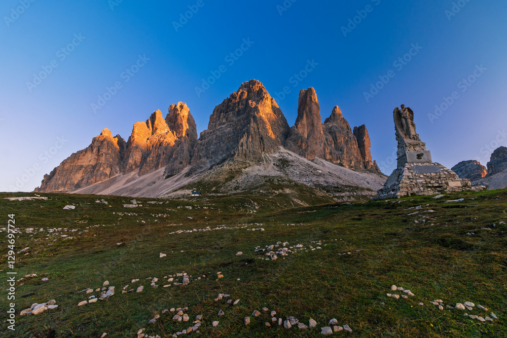Tre Cime di Lavaredo during sunrise with warm golden light