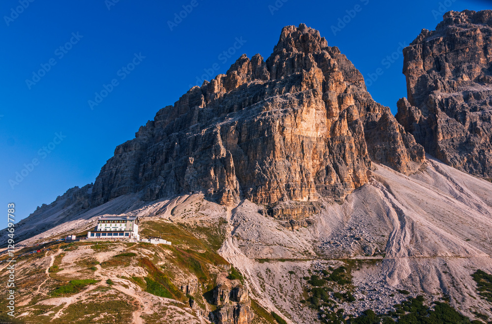 Tre Cime di Lavaredo during sunrise with warm golden light