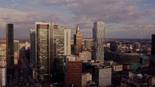 Palace of Culture and Science among the glass skyscrapers of Warsaw. Business center of a modern city from a bird's eye view, video from a drone.