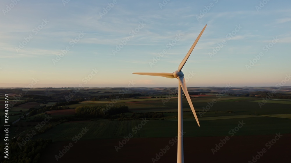 Fototapeta premium The drone flies at the level of the rotating blades of the wind generator around the propeller. Multicolored beautiful fields in the background, the Netherlands.