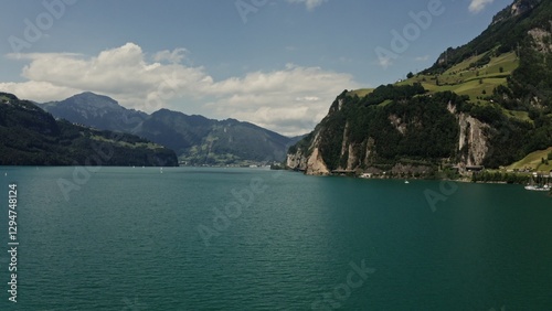 Horizontal panning from a drone, a view of a picturesque mountain valley with a beautiful large lake at the foot of the mountains. Switzerland, Lucerne, Alps