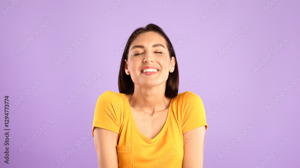Positive Emotions. Cheerful lady smiling with closed eyes, isolated over pastel purple studio wall, banner Positive Emotions. Cheerful lady smiling with closed eyes, isolated over pastel purple studio wall, banner