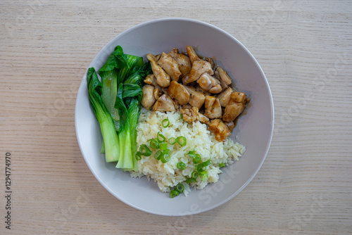 A plate of chicken with bok choy and rice.