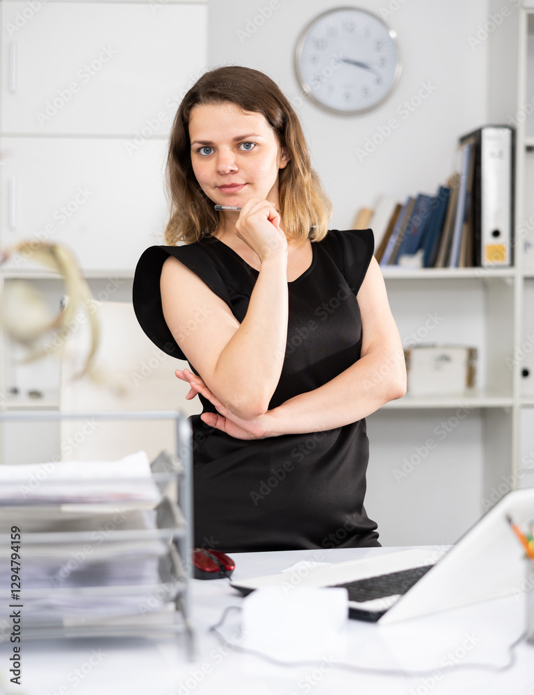Portrait of a business woman in a black dress in a modern office Portrait of a business woman in a black dress in a modern office