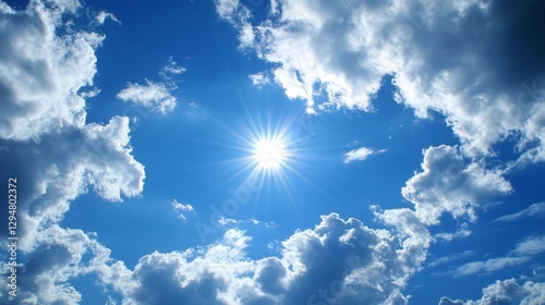 Bright Sun Shining Through Fluffy White Clouds in a Vivid Blue Sky