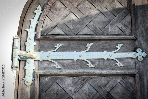 Vintage Wooden Door with Decorative Metal Hinge, Aged Texture and Architectural Detail photo