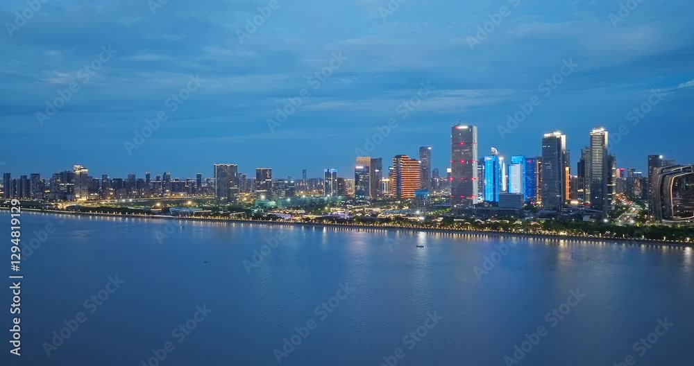 Aerial view of modern city skyline and commercial buildings at night along the river Aerial view of modern city skyline and commercial buildings at night along the river