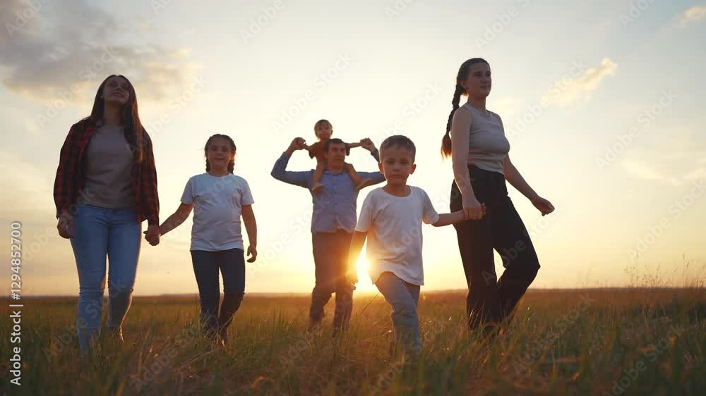 Silhouette of a large family walking in the park with children. Sunset happy family park concept. Silhouette of a family lifestyle walking together in garden Silhouette of a large family and walking. Silhouette of a large family walking in the park with children. Sunset happy family park concept. Silhouette of a family lifestyle walking together in garden Silhouette of a large family and walking.
