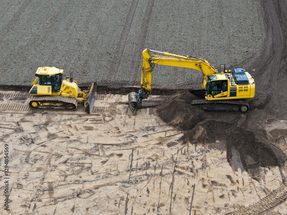 aerial view of an excavator and bulldozer at work on a construction site, road construction, earthworks, development aerial view of an excavator and bulldozer at work on a construction site, road construction, earthworks, development