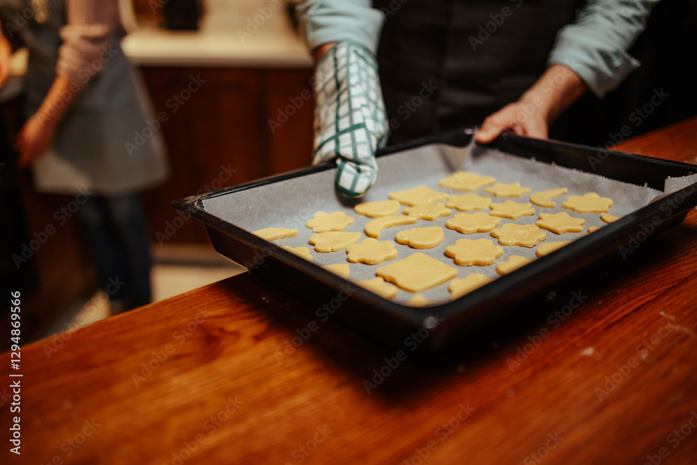 Fototapeta premium Baking freshly shaped cookies in a cozy kitchen